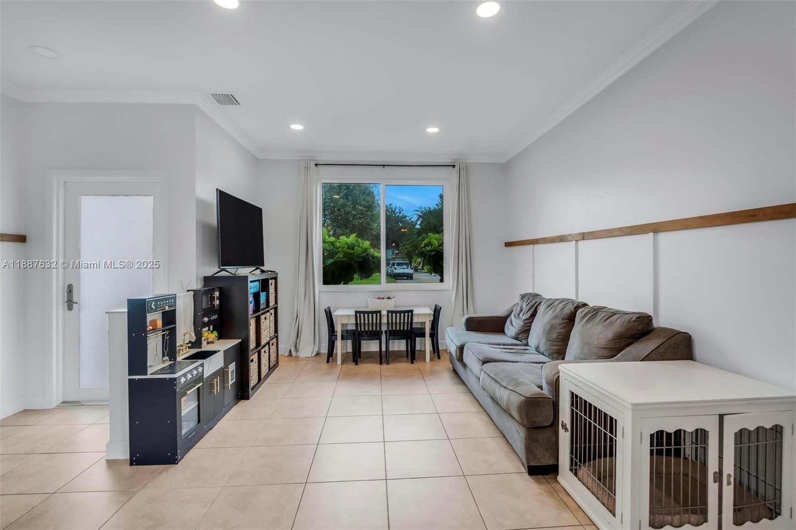 14836 Southwest 51st Street Davie, FL 33331 - Photo 13 of 34 a living room with furniture and a flat screen tv