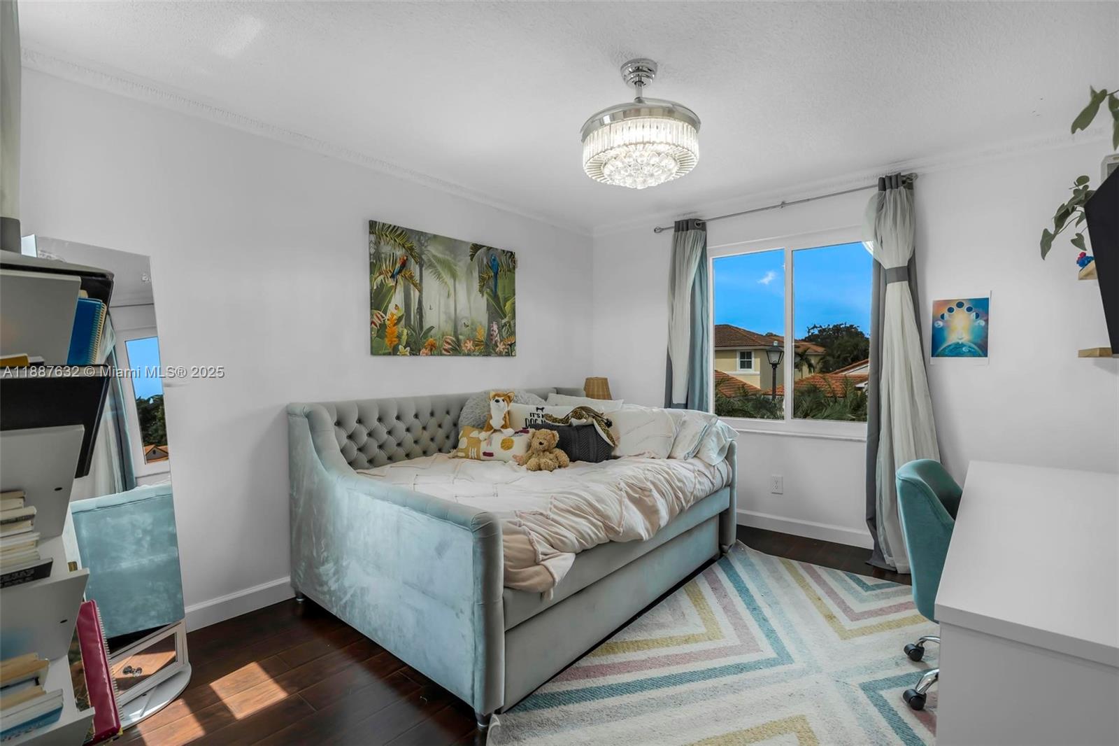 14836 Southwest 51st Street Davie, FL 33331 - Photo 19 of 34 a bedroom with a bed and a chandelier