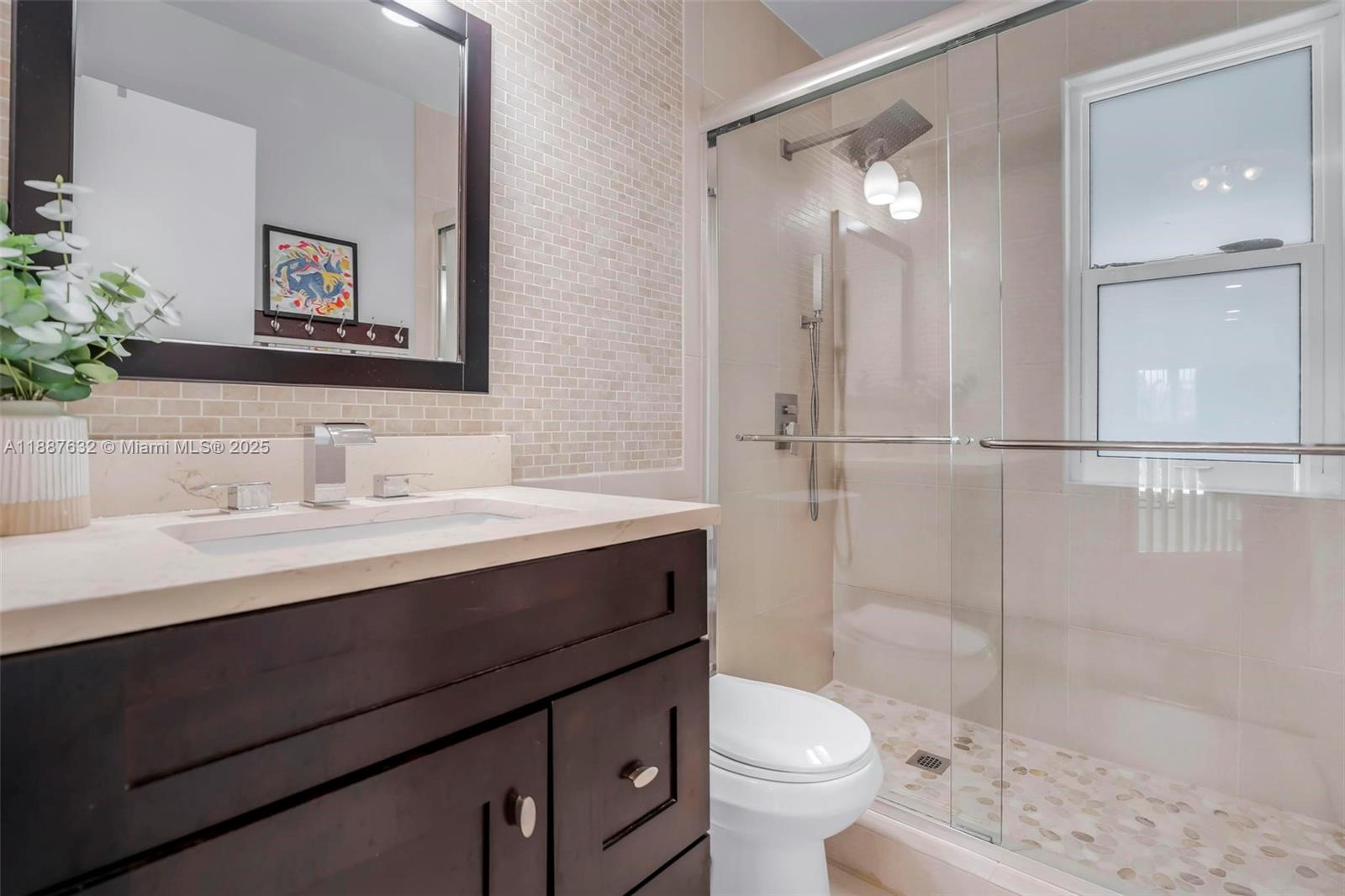 14836 Southwest 51st Street Davie, FL 33331 - Photo 20 of 34 a bathroom with a sink a toilet and shower