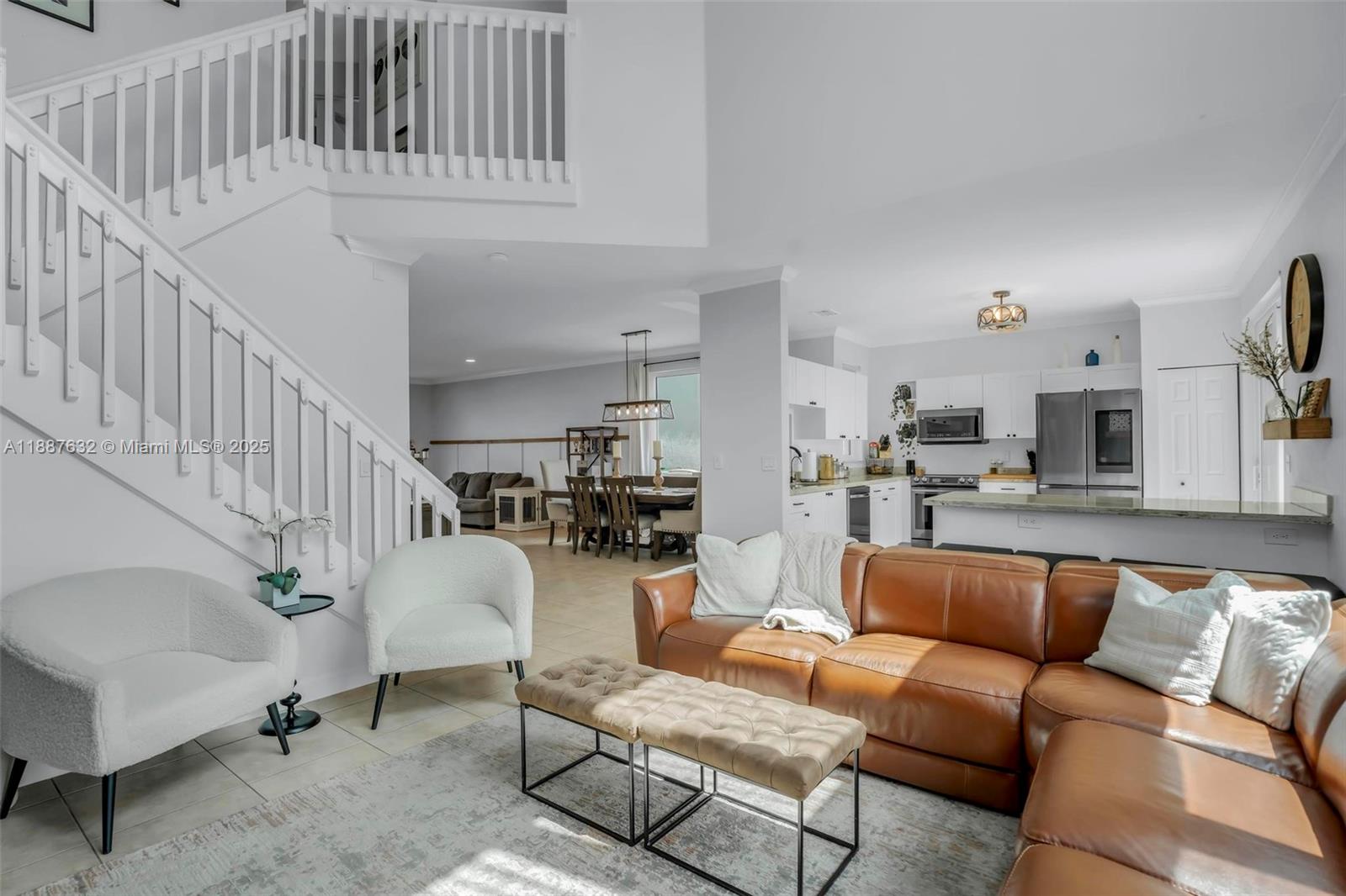 14836 Southwest 51st Street Davie, FL 33331 - Photo 2 of 34 a living room with furniture and a dining table with wooden floor