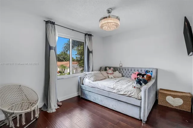 a bedroom with a bed and a chandelier