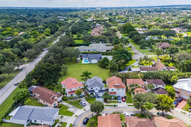 an aerial view of a city with lots of residential buildings ocean and mountain view
