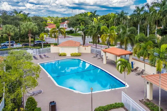 swimming pool view with a seating space and a garden view