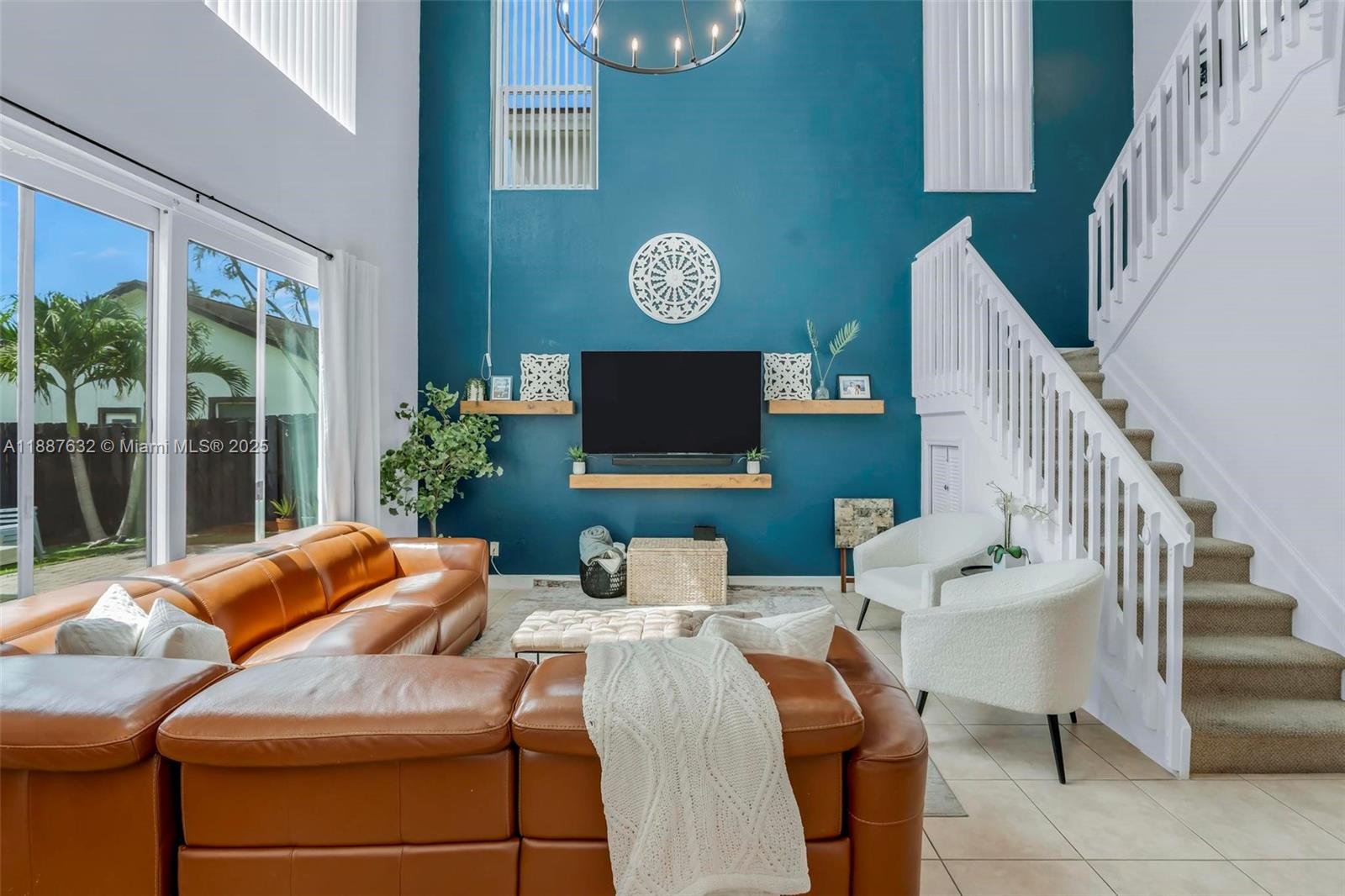 14836 Southwest 51st Street Davie, FL 33331 - Photo 5 of 34 a view of a livingroom with furniture a flat screen tv and floor to ceiling window