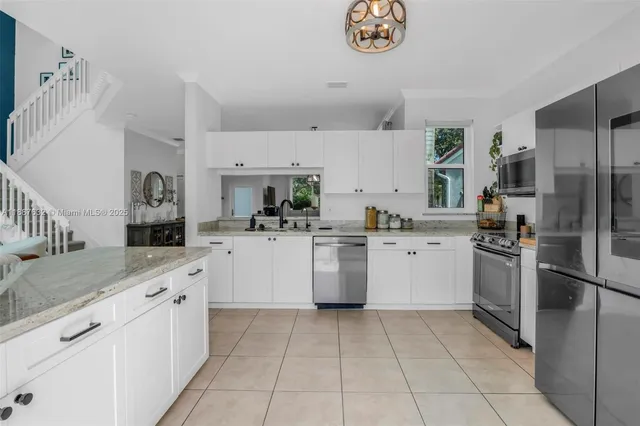 a kitchen with a sink cabinets and stainless steel appliances