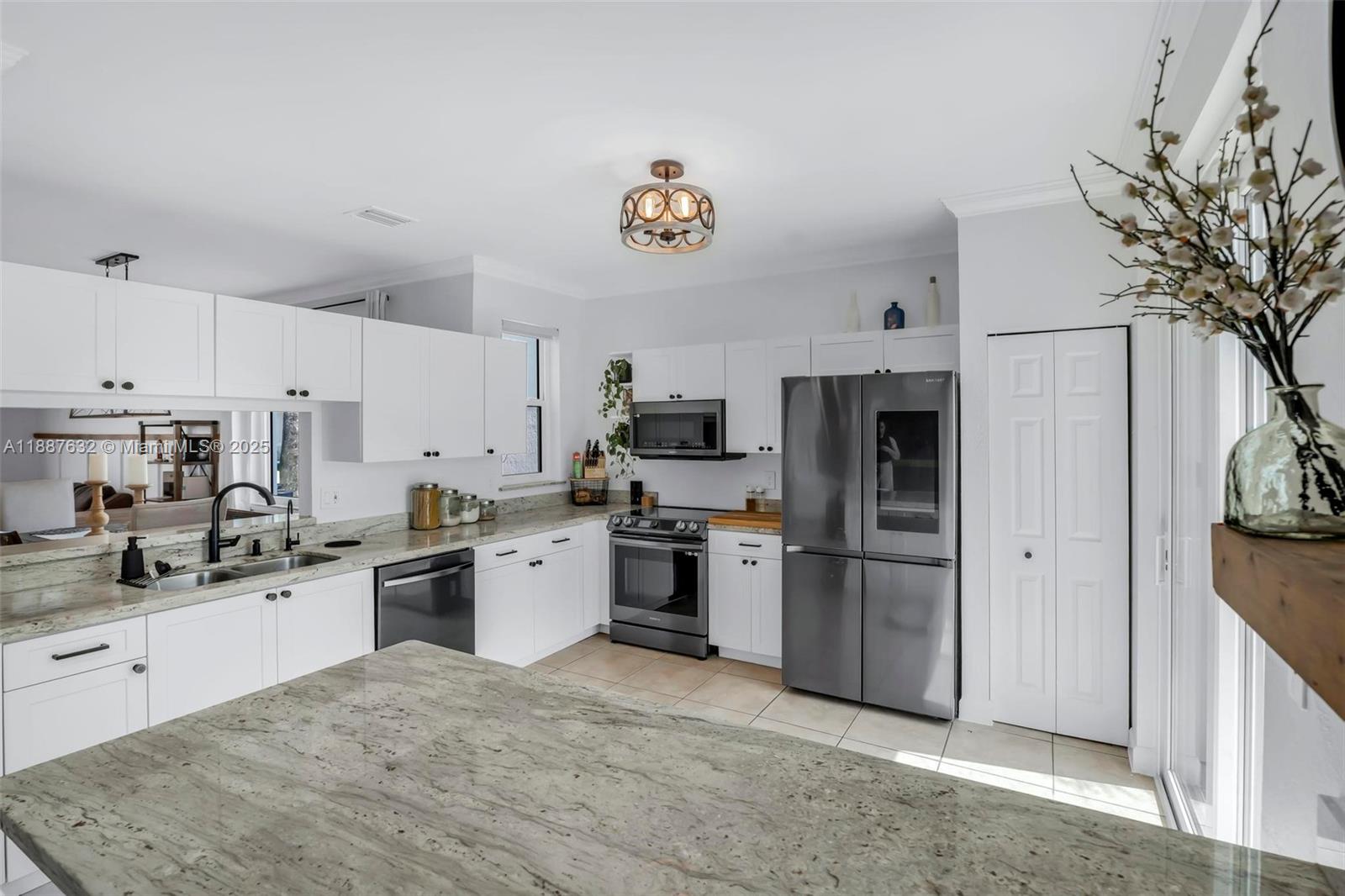 14836 Southwest 51st Street Davie, FL 33331 - Photo 7 of 34 a kitchen with stainless steel appliances granite countertop a refrigerator sink and stove