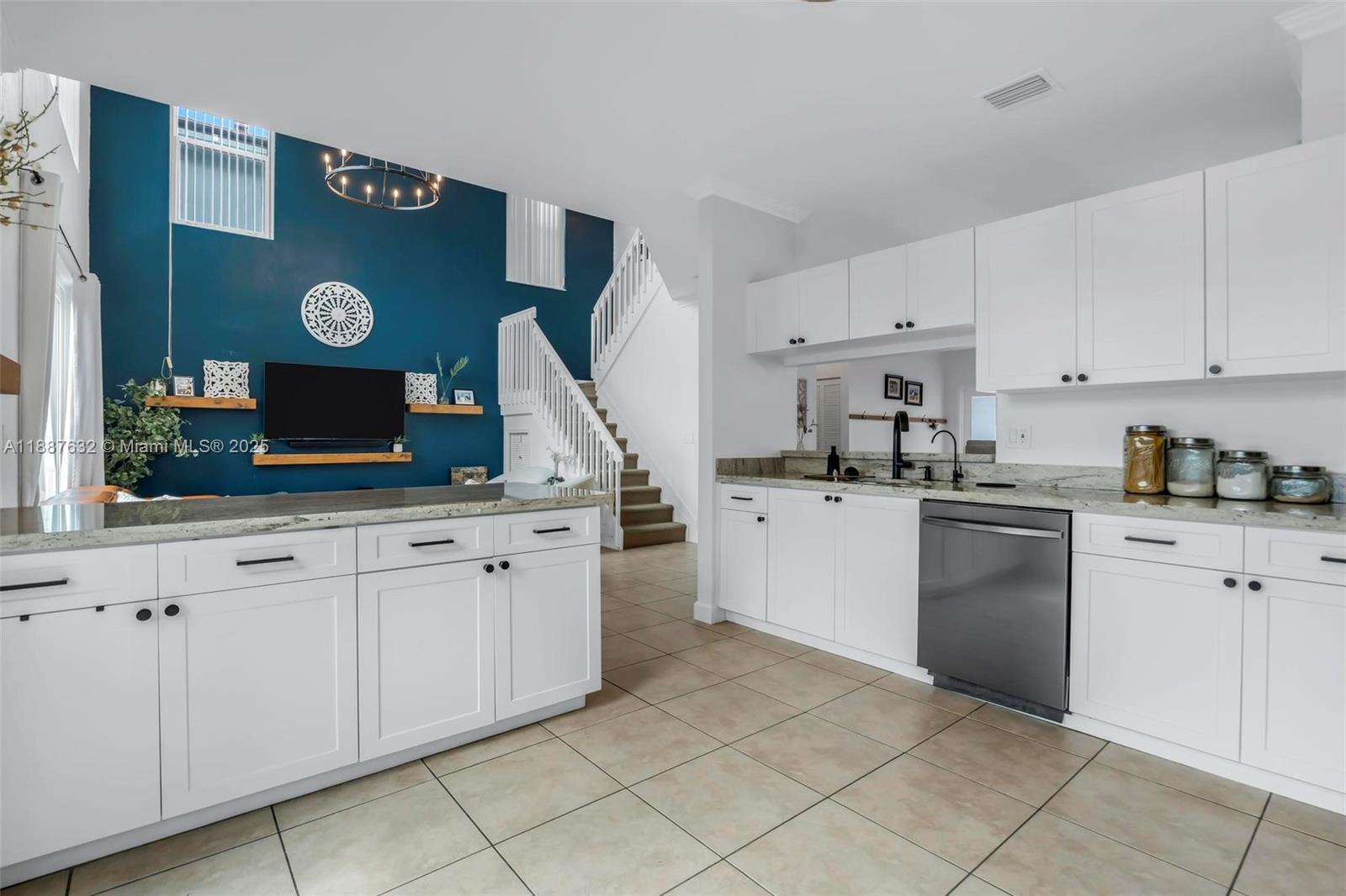 14836 Southwest 51st Street Davie, FL 33331 - Photo 9 of 34 a kitchen with stainless steel appliances granite countertop a sink and cabinets