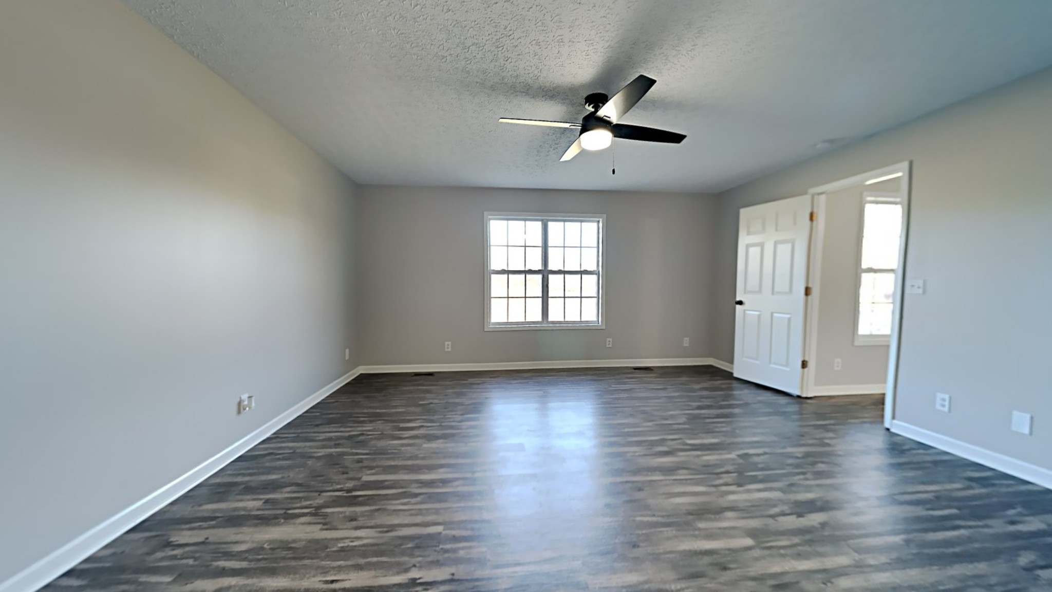 416 Jernigan Road Portland, TN 37148 - Photo 8 of 16 an empty room with wooden floor fan and windows