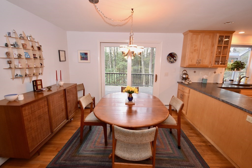227 Heatherstone Road Amherst, MA 01002 - Photo 12 of 42 a dining room with furniture and wooden floor