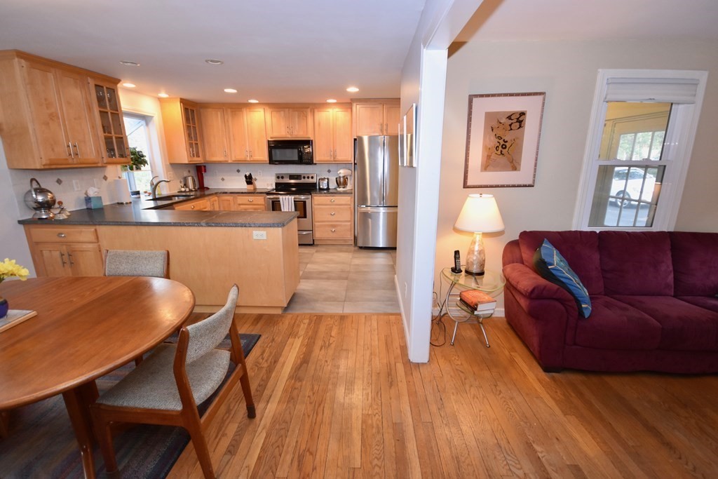227 Heatherstone Road Amherst, MA 01002 - Photo 15 of 42 a living room with stainless steel appliances granite countertop furniture wooden floor and a kitchen view