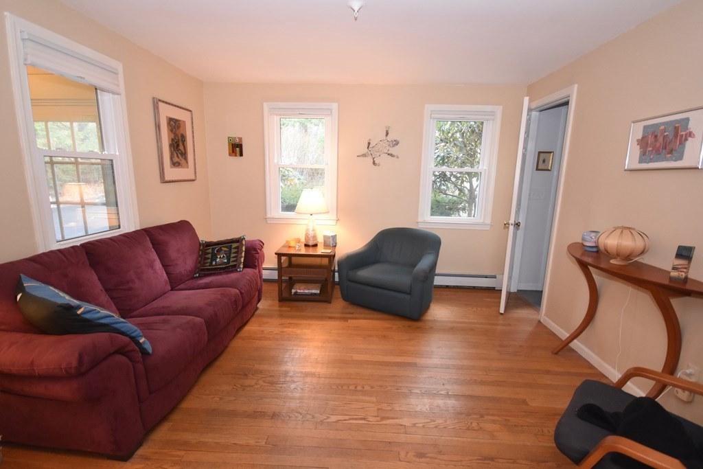 227 Heatherstone Road Amherst, MA 01002 - Photo 16 of 42 a living room with furniture window and a wooden floor