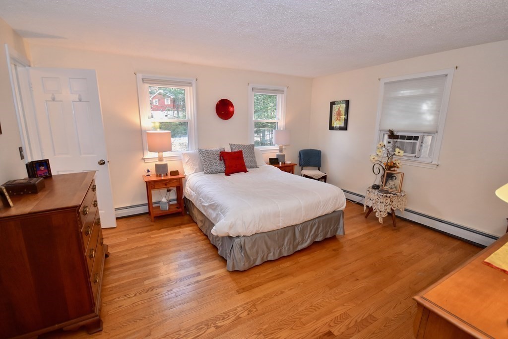 227 Heatherstone Road Amherst, MA 01002 - Photo 20 of 42 a bedroom with a bed and wooden floor