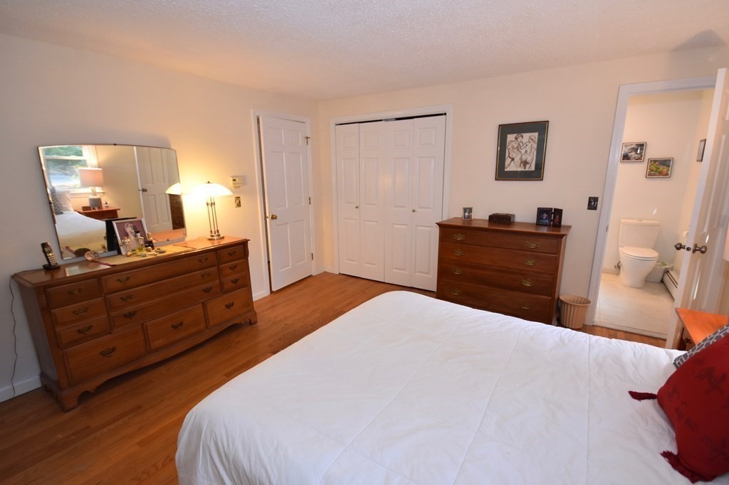 227 Heatherstone Road Amherst, MA 01002 - Photo 21 of 42 a bedroom with a bed and a dresser