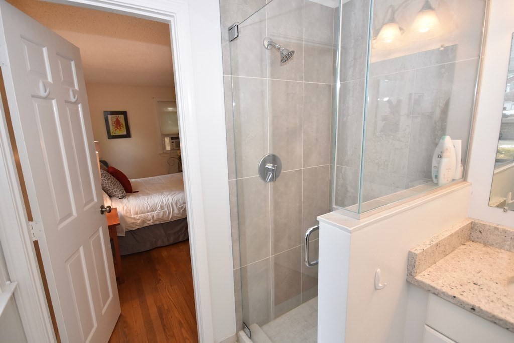 227 Heatherstone Road Amherst, MA 01002 - Photo 23 of 42 a bathroom with a granite countertop shower and a sink