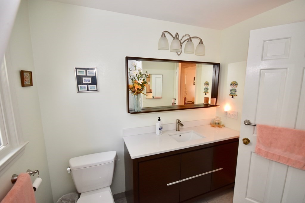 227 Heatherstone Road Amherst, MA 01002 - Photo 30 of 42 a bathroom with a sink mirror vanity and toilet