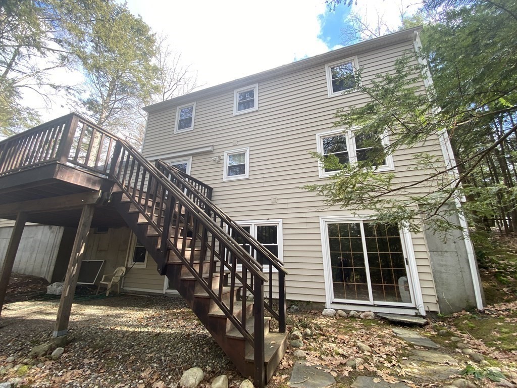 227 Heatherstone Road Amherst, MA 01002 - Photo 40 of 42 a view of a house with backyard and wooden fence