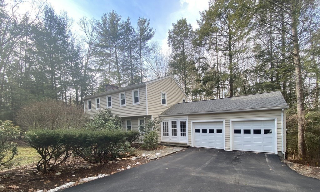 227 Heatherstone Road Amherst, MA 01002 - Photo 41 of 42 a view of a white house next to a road and yard