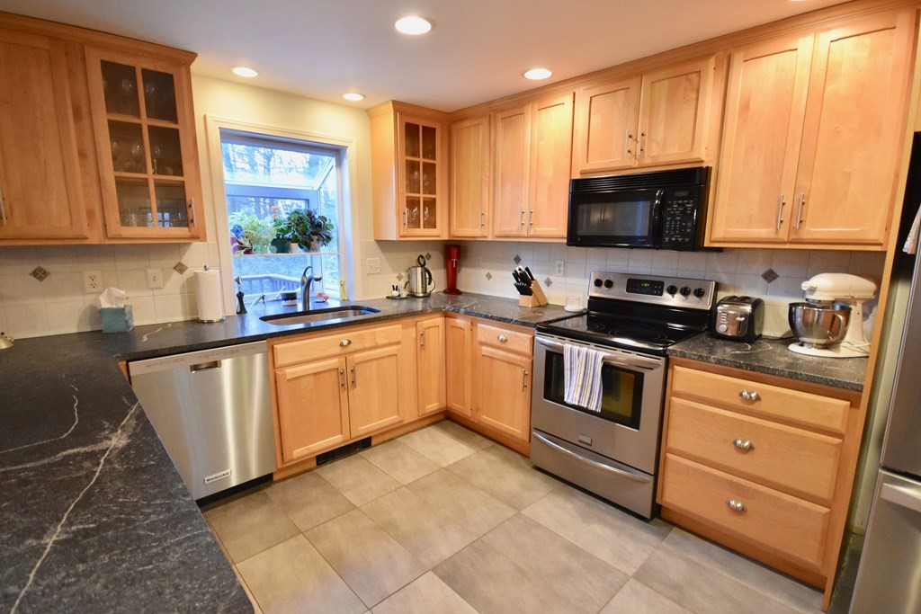 227 Heatherstone Road Amherst, MA 01002 - Photo 8 of 42 a kitchen with stainless steel appliances granite countertop a sink a stove and cabinets