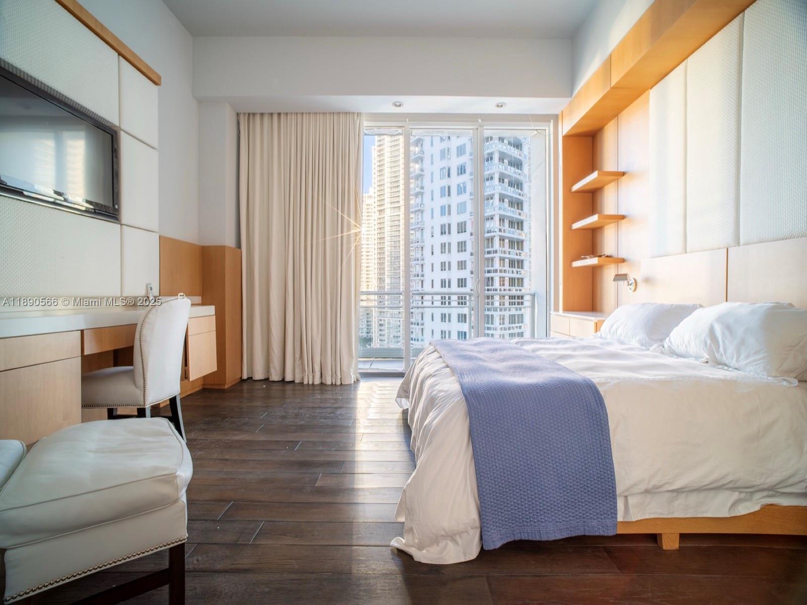 900 Brickell Key Boulevard, Unit 2204 Miami, FL 33131 - Photo 13 of 40 a bedroom with a bed and a couch