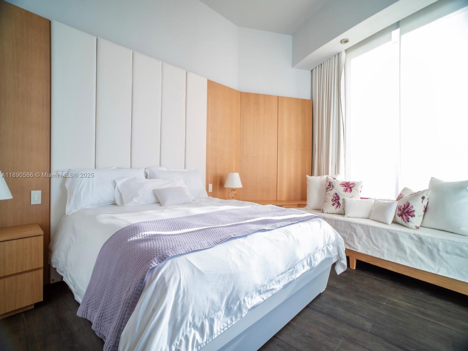 900 Brickell Key Boulevard, Unit 2204 Miami, FL 33131 - Photo 18 of 40 a bedroom with bed and window