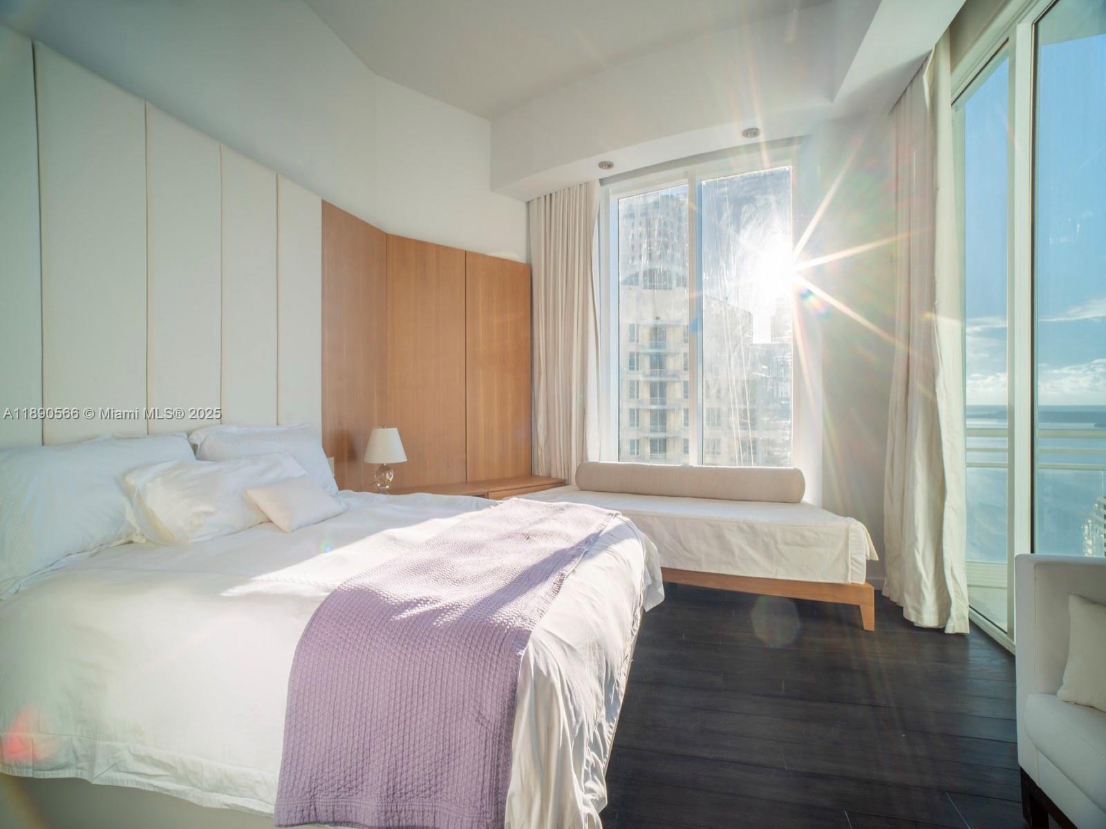 900 Brickell Key Boulevard, Unit 2204 Miami, FL 33131 - Photo 19 of 40 a bedroom with a bed and a large window