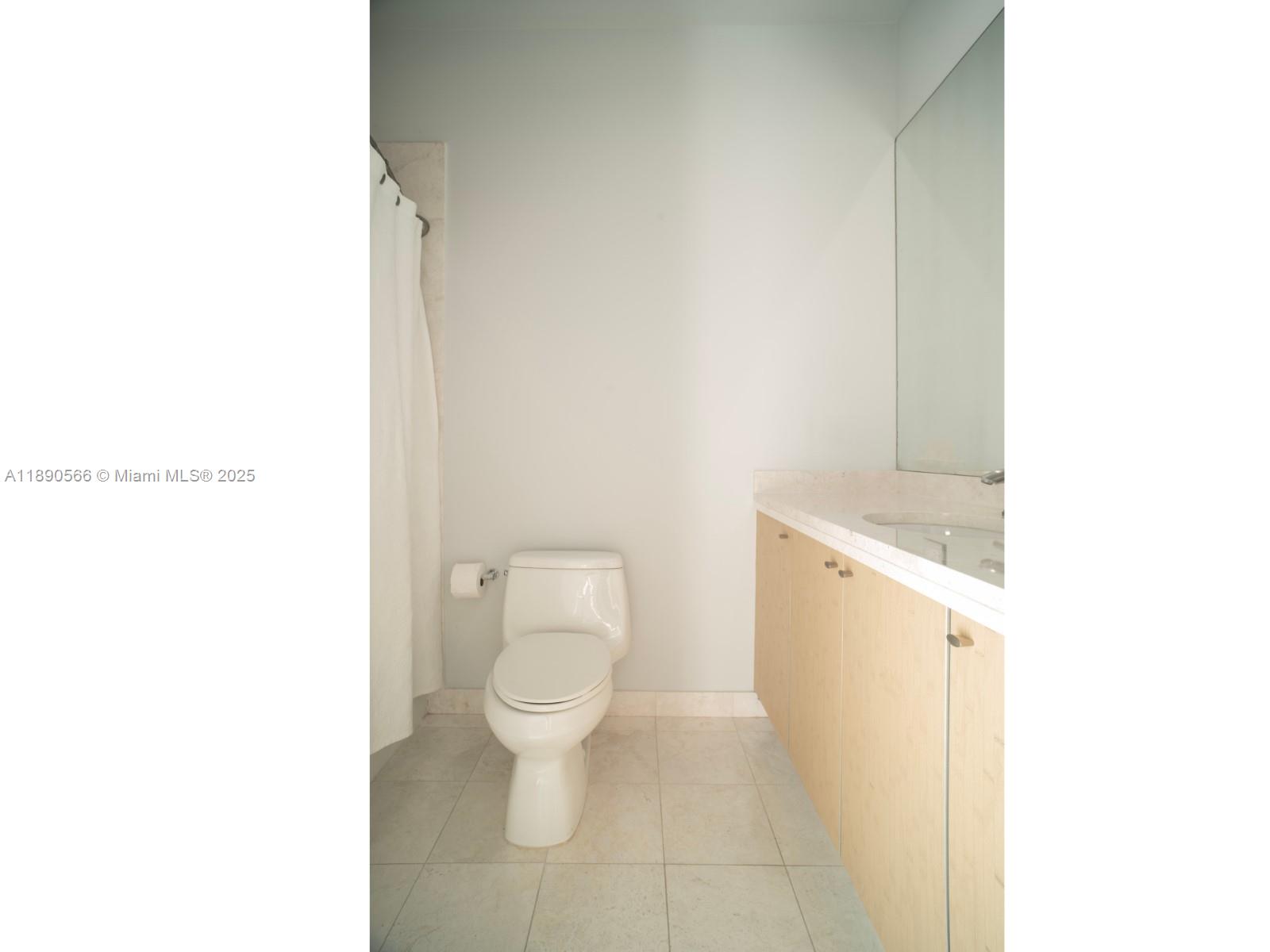 900 Brickell Key Boulevard, Unit 2204 Miami, FL 33131 - Photo 20 of 40 a white toilet sitting next to a white sink