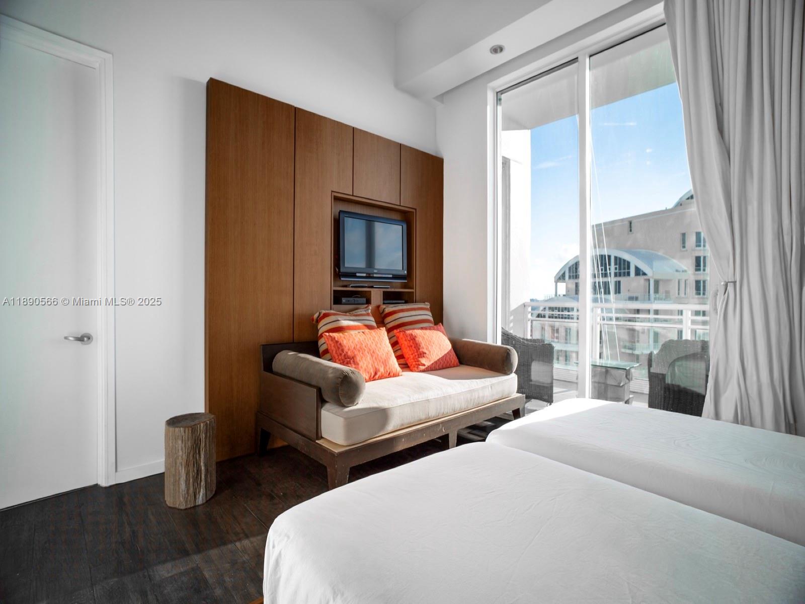 900 Brickell Key Boulevard, Unit 2204 Miami, FL 33131 - Photo 21 of 40 a bedroom with two beds and a large window