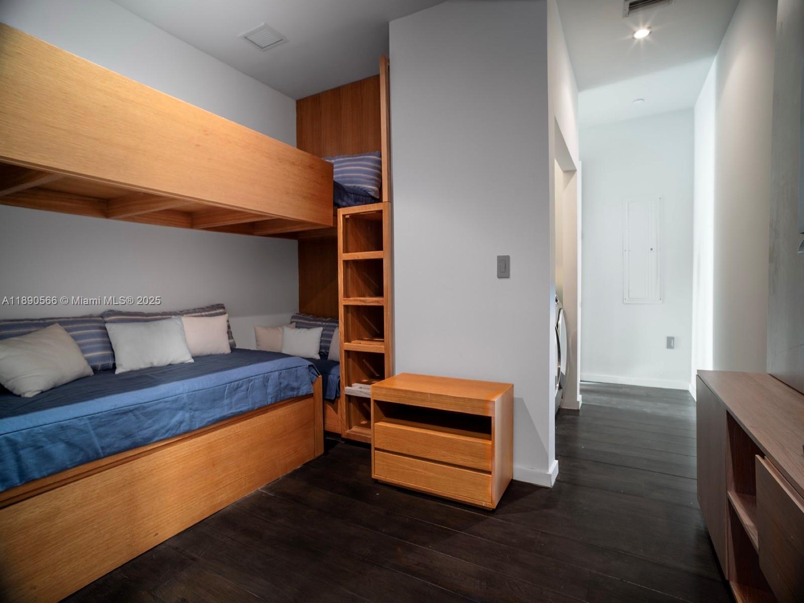 900 Brickell Key Boulevard, Unit 2204 Miami, FL 33131 - Photo 23 of 40 a room with wooden floor and furniture