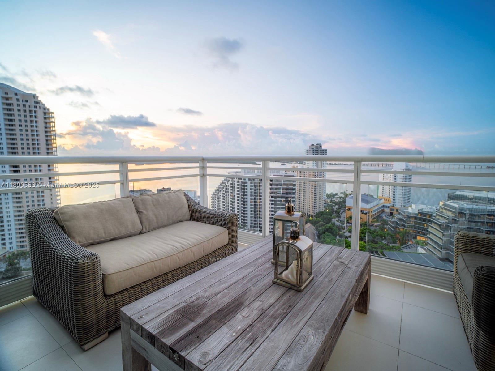 900 Brickell Key Boulevard, Unit 2204 Miami, FL 33131 - Photo 3 of 40 a view of roof deck with couches and wooden floor