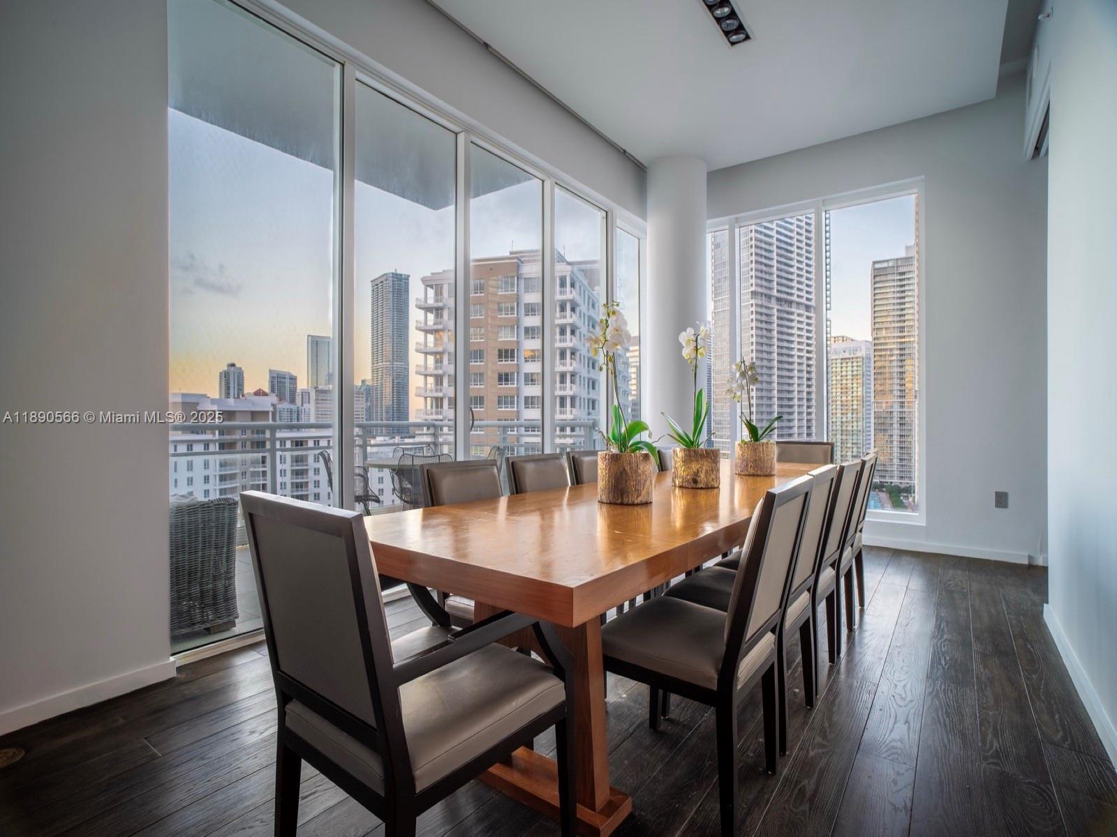 900 Brickell Key Boulevard, Unit 2204 Miami, FL 33131 - Photo 4 of 40 a view of a dining room with furniture window and wooden floor