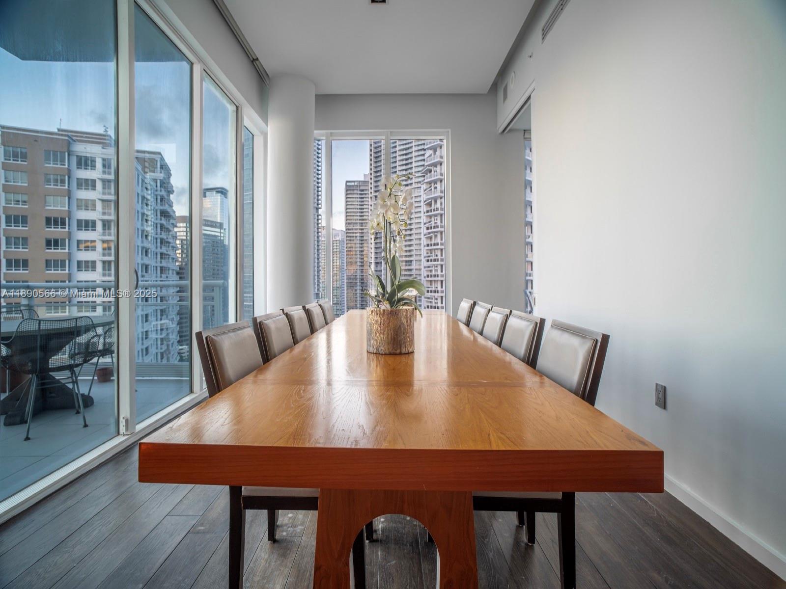 900 Brickell Key Boulevard, Unit 2204 Miami, FL 33131 - Photo 5 of 40 a view of a dining room with furniture and wooden floor