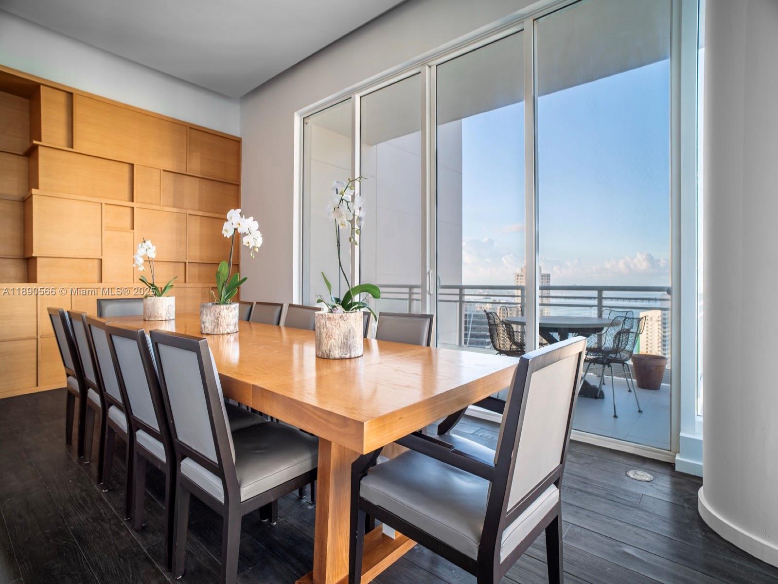 900 Brickell Key Boulevard, Unit 2204 Miami, FL 33131 - Photo 6 of 40 a view of a dining room with furniture and wooden floor