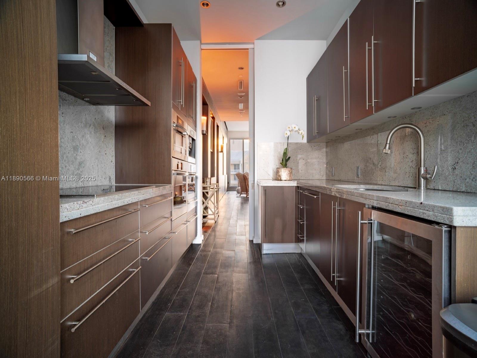 900 Brickell Key Boulevard, Unit 2204 Miami, FL 33131 - Photo 7 of 40 a kitchen with stainless steel appliances a stove and a refrigerator