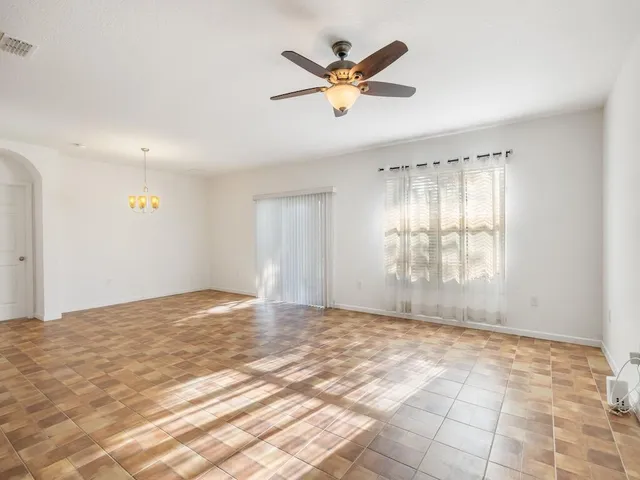 a view of a livingroom with a ceiling fan and window