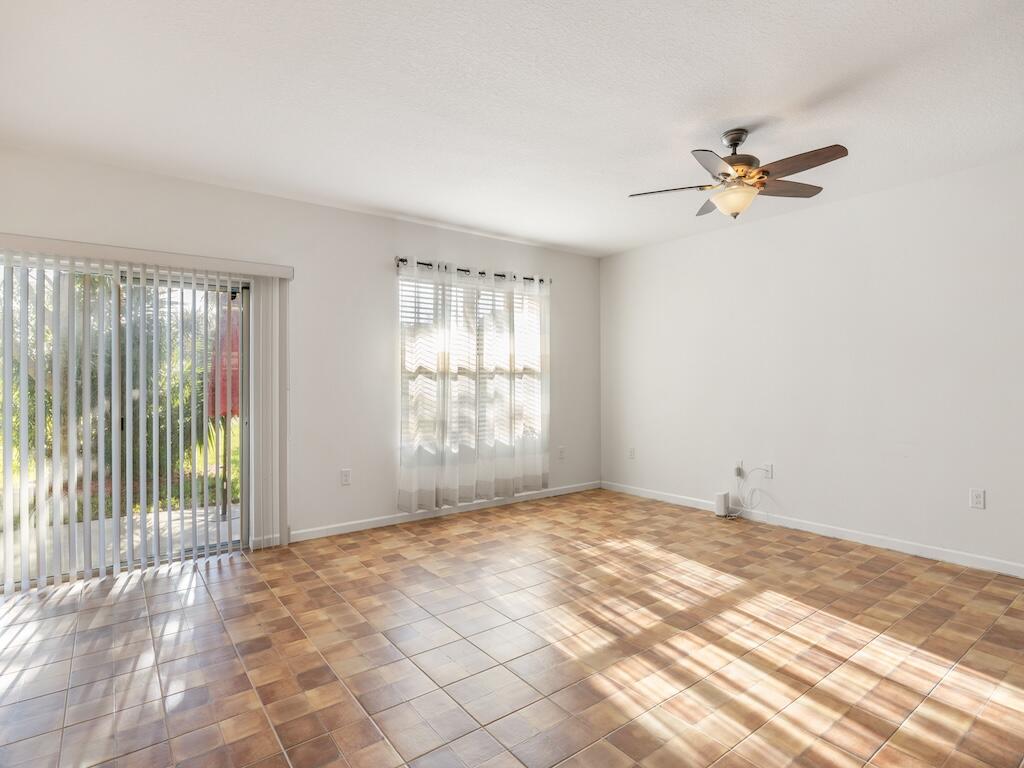 1440 Lexington Square Southwest Vero Beach, FL 32962 - Photo 14 of 41 an empty room with windows and fan