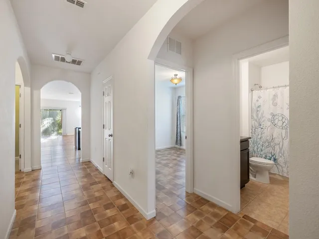 a view of a hallway view with wooden floor and bathroom