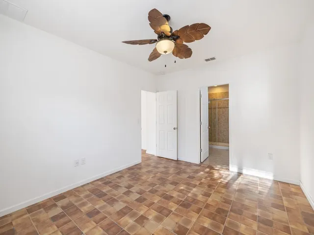 a view of a room with a ceiling fan and a large window