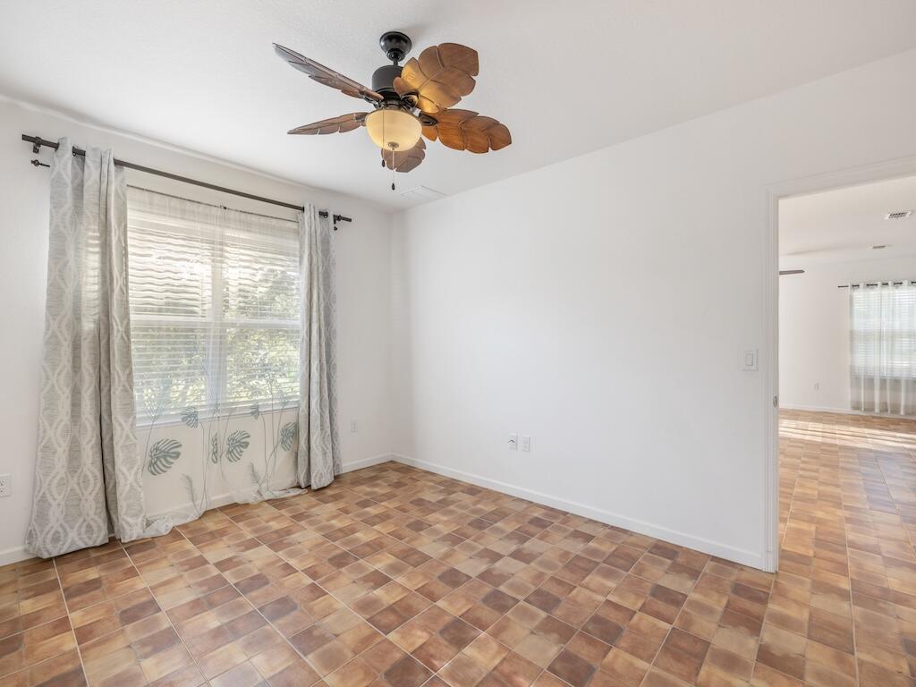 1440 Lexington Square Southwest Vero Beach, FL 32962 - Photo 28 of 41 a view of a room with a ceiling fan and a large window