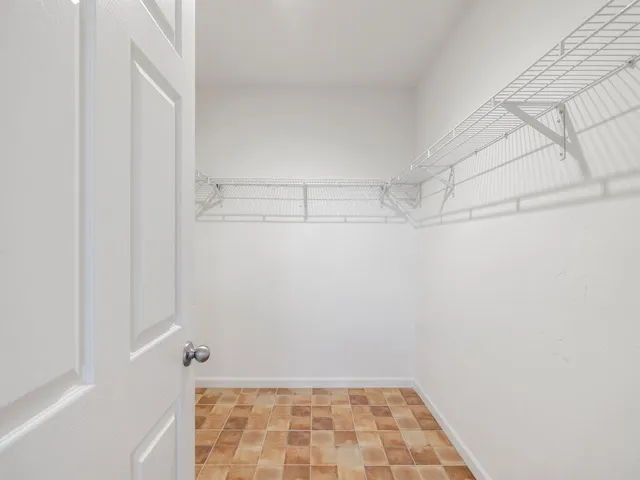 a bathroom with a granite countertop sink a mirror a bathtub and next to a window