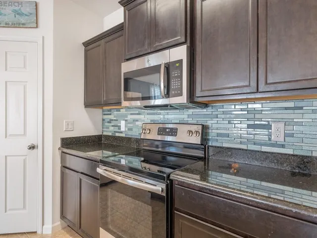 a stove top oven sitting inside of a kitchen
