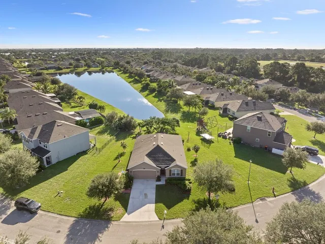 an aerial view of a house with a yard basket ball court and outdoor seating