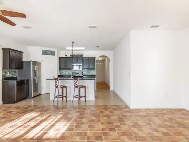 a view of kitchen with sink microwave and refrigerator