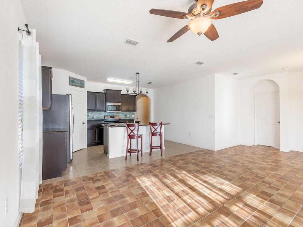 1440 Lexington Square Southwest Vero Beach, FL 32962 - Photo 8 of 41 a kitchen with stainless steel appliances kitchen island granite countertop a refrigerator and a sink