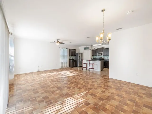 a view of a kitchen with a sink and cabinets