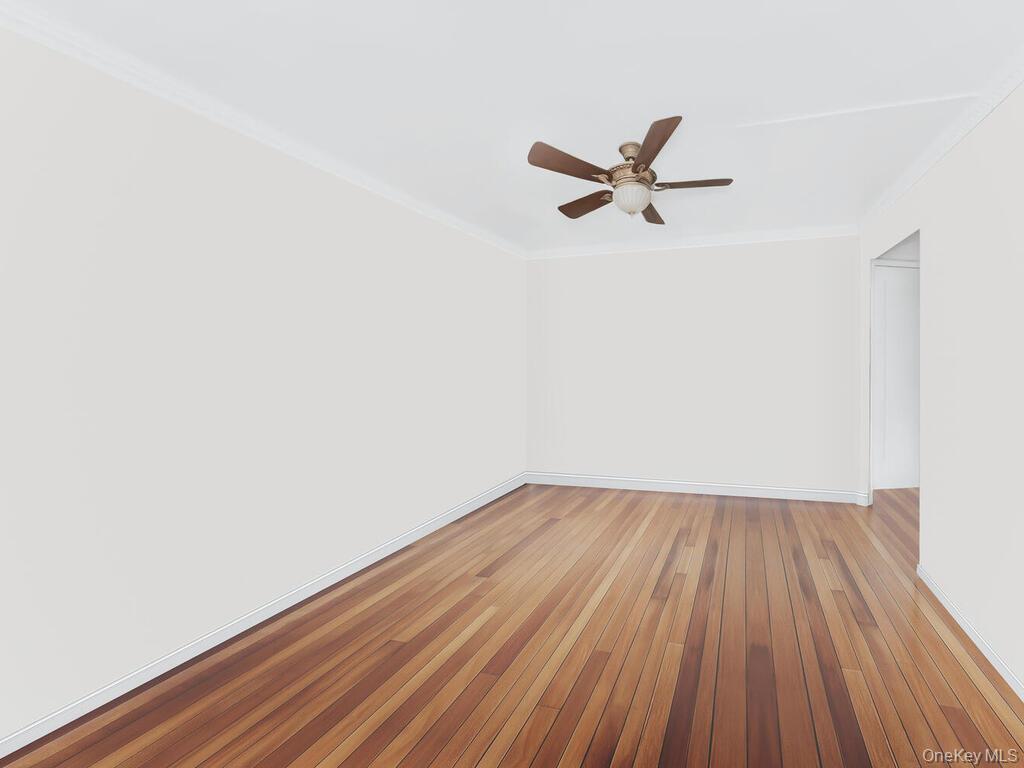 1475 Thieriot Avenue, Unit 5N Bronx, NY 10460 - Photo 13 of 22 a view of a room with wooden floor and a ceiling fan