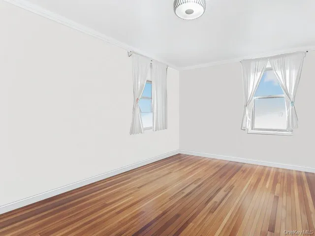 a view of a room with wooden floor