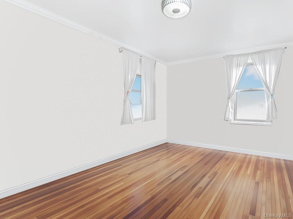 1475 Thieriot Avenue, Unit 5N Bronx, NY 10460 - Photo 16 of 22 an empty room with wooden floor and windows