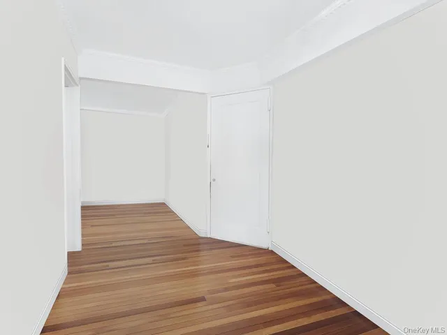 a bedroom with a large bed a lamp and a window