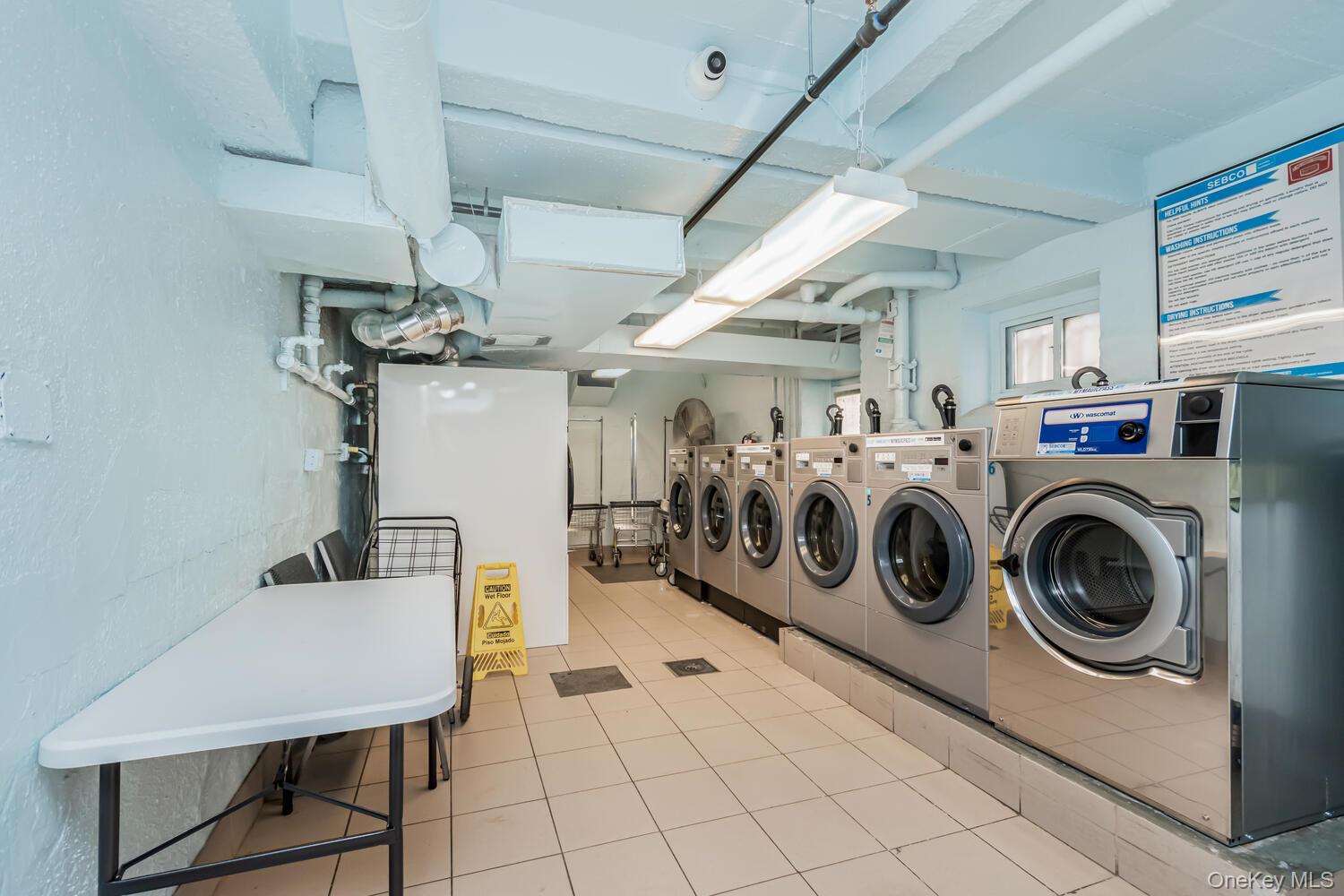 1475 Thieriot Avenue, Unit 5N Bronx, NY 10460 - Photo 19 of 22 a utility room with dryer washer and a view of kitchen