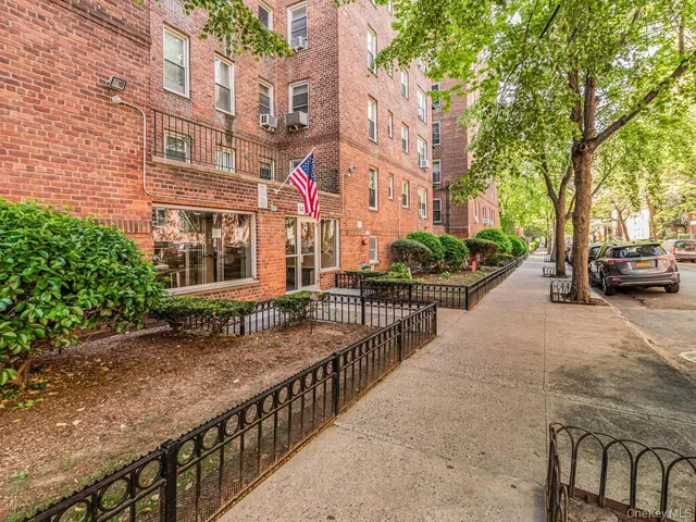 a view of a street with cars on brick road